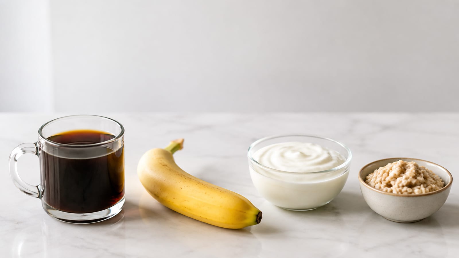 Post-workout coffee beside carbohydrates and protein arranged on a kitchen counter
